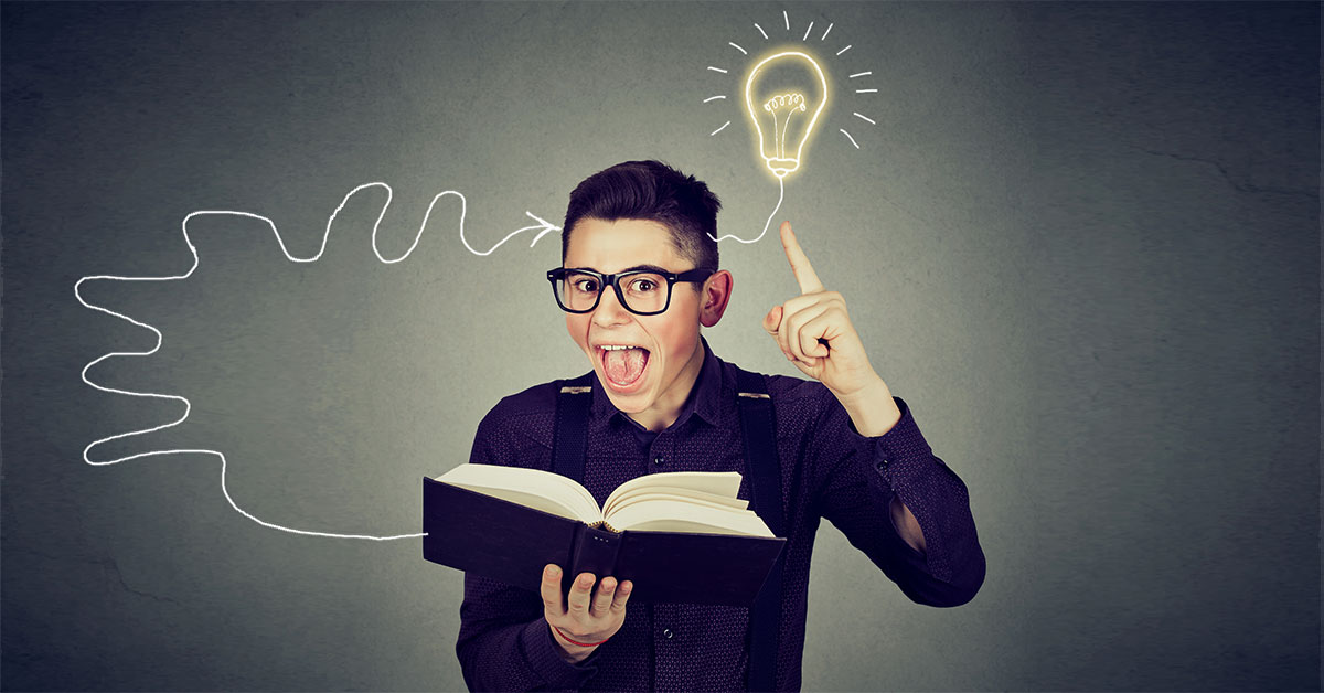 Amazed man in glasses reading book comes up with an idea
